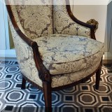 F53. Antique carved French style bergere chair upholstered in Fortuny fabric. 34”h 